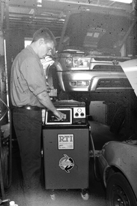 Photo of Triangle Service Center, Inc. Employee working on a vehicle